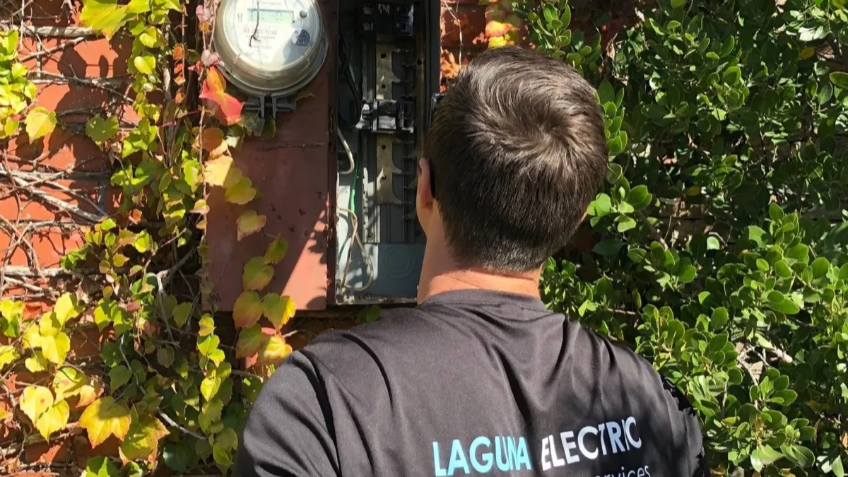 Laguna Electric technician servicing outdoor electrical panel